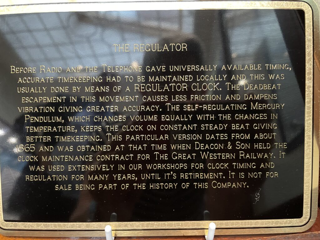Explanatory plaque on the regulator clock in Deacon's