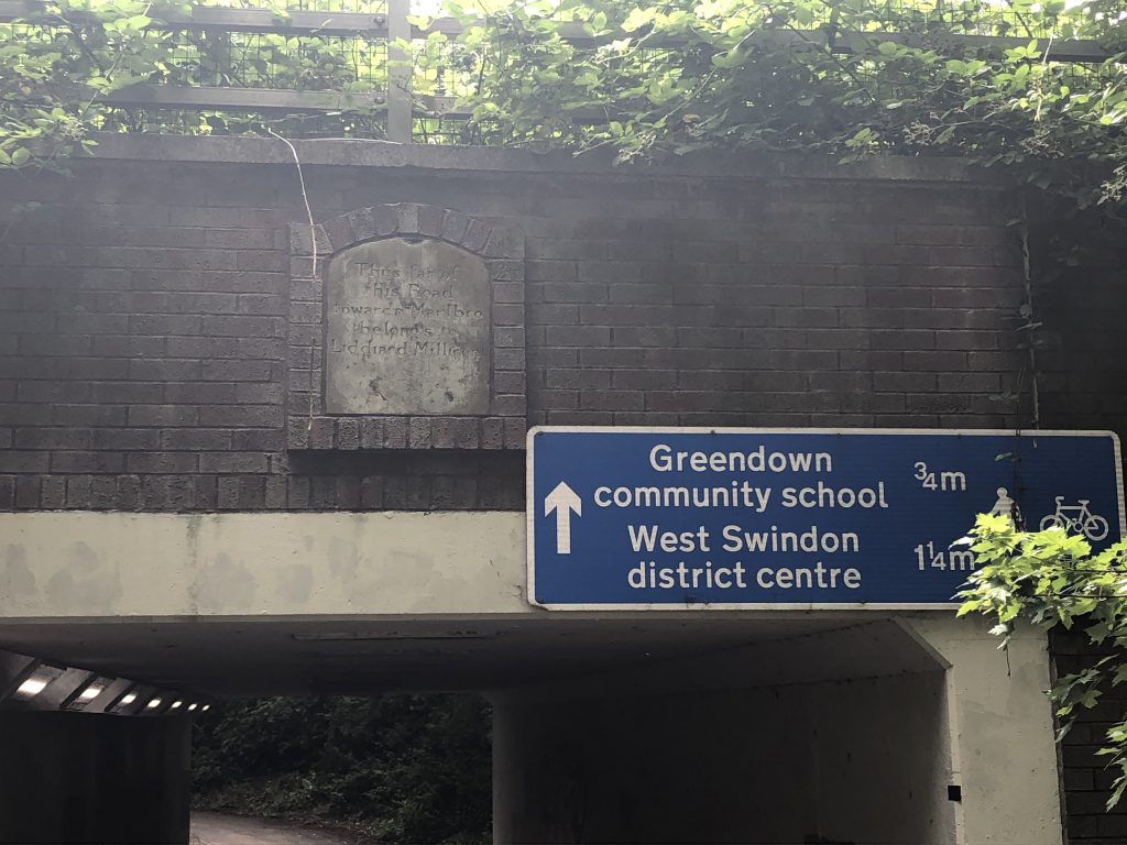 Old milestone set into an underpass