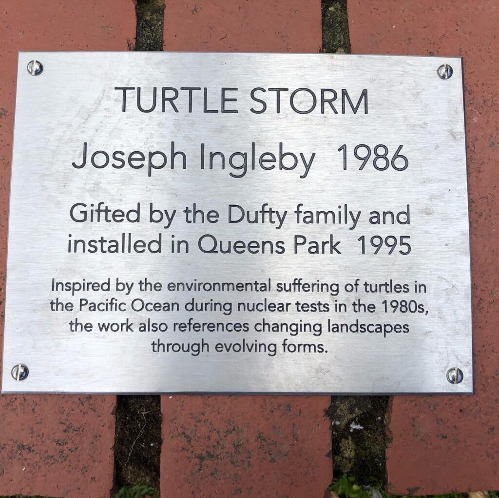The new plaque on the Turtle Storm sculpture in Queen's park swindon
