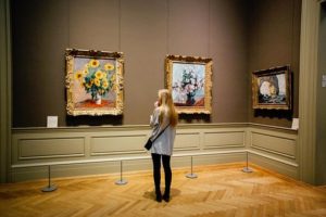 Culture and the High Street - woman looking at artworks in an art gallery