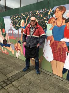 New Mural at Regent Circus - artist Tim Carroll standing with his mural
