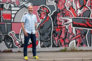 Mindset Coach Results Pressure Tips - John Lewis in front of graffiti