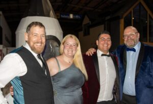 Birthday Bash Raises Cash - Jamie McAnsch, keynote speaker at their 10th birthday business partner, Danielle Holmes and Kyle Holmes, co-founders of Black Nova Designs, with Jeff Tucker of Best Mates.