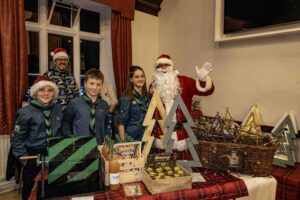Malmesbury's Christmas shopping night - Santa with gifts and Scouts