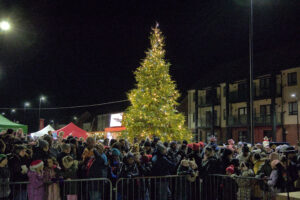Community Spirit Shines Bright - Christmas tree and crowd of people
