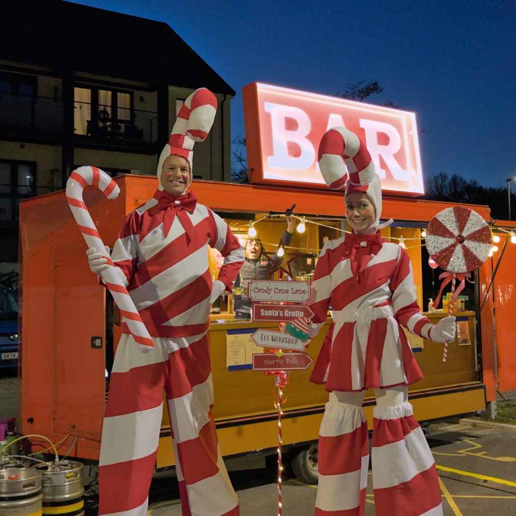 Stilt walkers dressed as candy canes