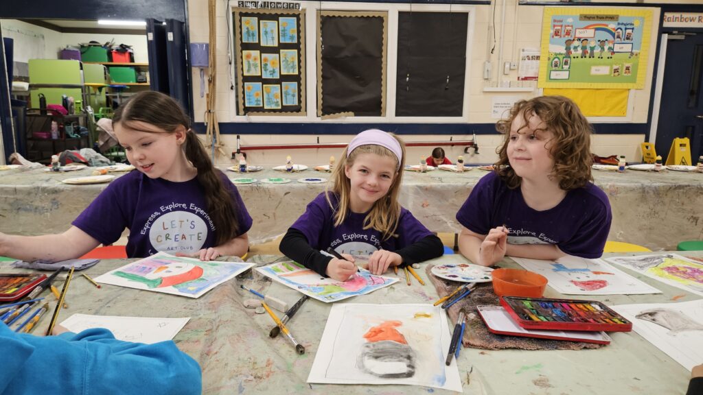 Three girls working at the  Let's create art club in Swindon 