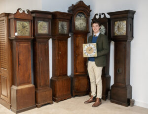 Grandfather Clocks at Auction - one of the Wiltshire-made grandfather clocks from the collection going under the hammer at RWB Auctions with junior auctioneer and valuer Will Walter