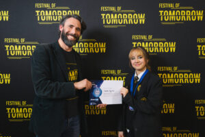 Swindon FameLab Academy Winner - Winner-Isabel-Aguilar-accepts-certificte-from-Rod-Hebden-Festival-director