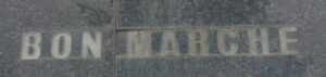Ghostly Bon Marche letters with the brass removed on the side of the old Debenhams building