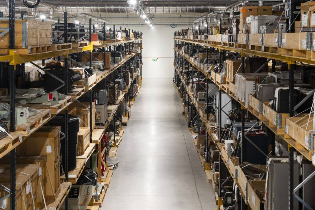 View of objects on racking shelving inside Building One (B1) at the National Collections Centre (NCC), Wiltshire.Photographed January 2024.