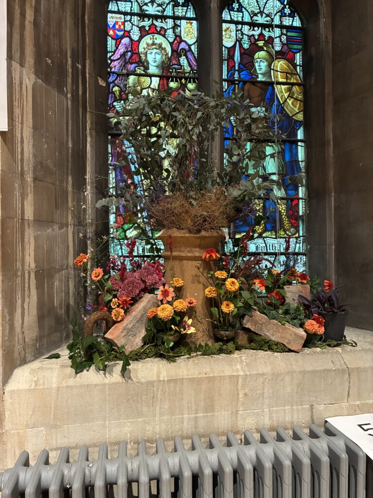 Floral display and stained glass window in Christ Church